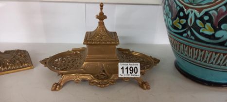 A Victorian brass inkwell