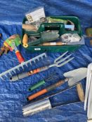 A garden tool tray with assorted hand tools
