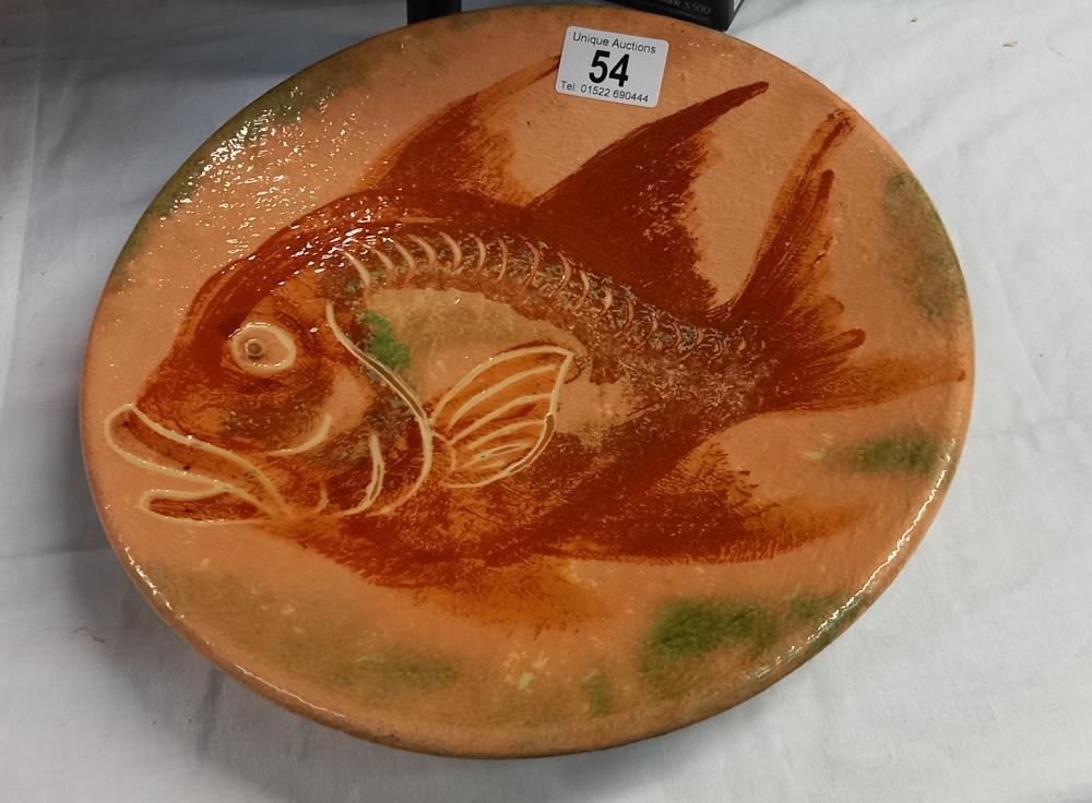 A pottery plate depicting a fish