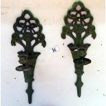 A pair of cast iron wall candle holders