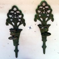 A pair of cast iron wall candle holders