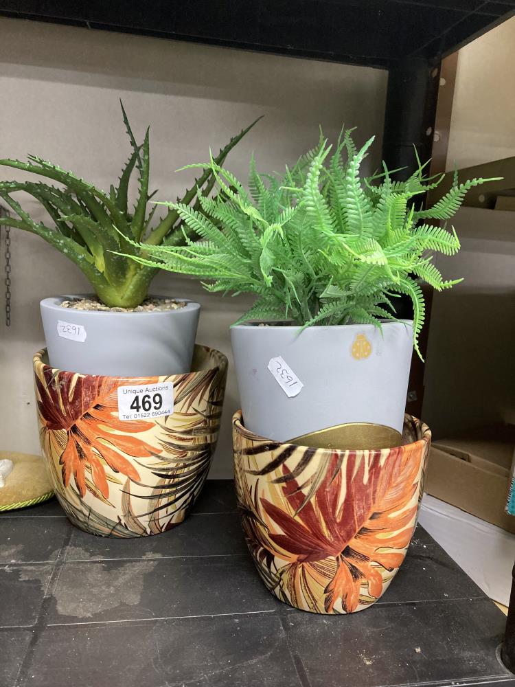 A faux Aloe Vera plant in pot a ceramic plant pot & one other