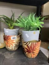 A faux Aloe Vera plant in pot a ceramic plant pot & one other