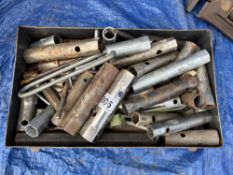 A collection of long sockets in tin tray