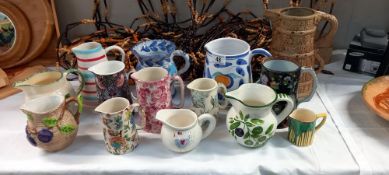 A good lot of decorative jugs including Mason Cash & Poole pottery etc