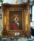 A gilt framed picture of a dog