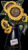 A cast sunflower door stop