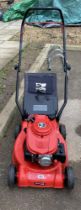 A red Einhell petrol lawn mower, starts but needs attention COLLECT ONLY