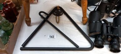 A large ornamental iron triangle musical instrument