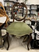 A victorian Balloon back chair