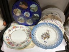 A collection of hanging wall plates & blue tin