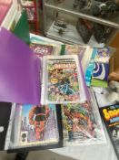 A collection of comics in folders, mainly Marvel including 1970s, X-Men, Inhumans, etc.