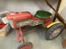 A vintage triang ride on pedal tractor