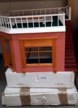 A corner shop and boxed part 2 first floor and roof plus a boxed Tudor top of house dolls house