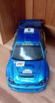 A battery remote control Subaru Impreza rally car. Untested handset. Approximately 42cm