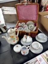 A Wicker basket of child's pottery tea set & 1 other set