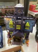 A Scooby Doo haunted mansion & figures