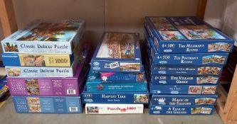 A large quantity of jigsaws many unopened (inside)