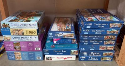 A large quantity of jigsaws many unopened (inside)