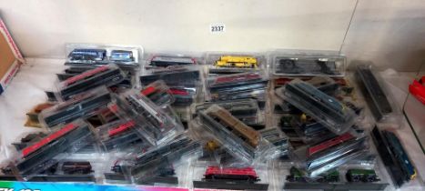 A quantity of unpowered 'N' Gauge model trains in packaging