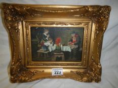 A gilt framed dining room scene.