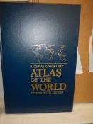 A large boxed and new world atlas.