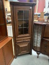 Tall dark wood unit Glass fronted top