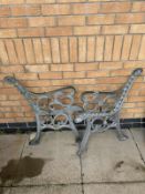 A pair of cast iron garden bench ends.