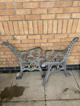 A pair of cast iron garden bench ends.