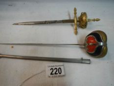Two sword shaped letter openers (one with scabbard).