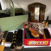 A collection of Shoe and clothes brushes, shoe polishes and a green shoeshine caddy