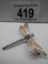 An enamel dragonfly brooch.