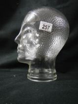 A glass male head.