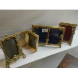 A quantity of brass photo frames.