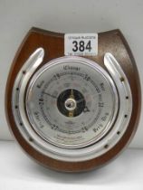 A horse shoe shaped barometer.