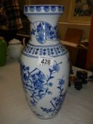 A tall blue and white vase.