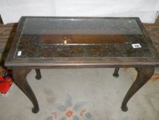 A carved top coffee table with glass top, COLLECT ONLY.