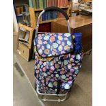 A wheeled shopping trolly ,cool bag and one other bag