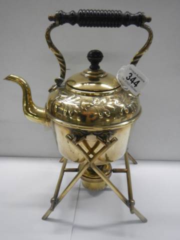 An old brass spirit kettle on stand.