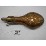 A Victorian copper gunpowder flask (damage to top spring otherwise in good condition).