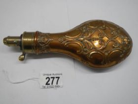 A Victorian copper gunpowder flask (damage to top spring otherwise in good condition).