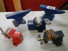 Two small anvils and three small vices.