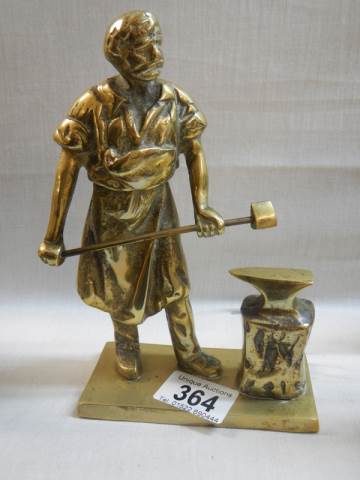 A solid brass blacksmith figure.