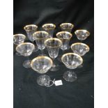 Two sets of six glasses with gilded rims.