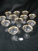 Two sets of six glasses with gilded rims.