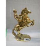 A solid brass rearing horse figure.