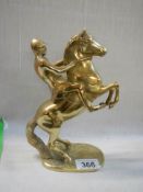 A solid brass rearing horse figure.