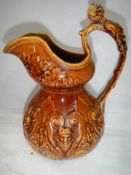 A good early 20th century crackle glaze jug with figural handle.