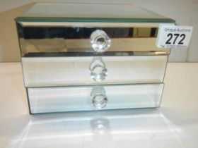 A small three drawer mirrored jewellery chest.