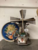A decorative windmill and vintage tin